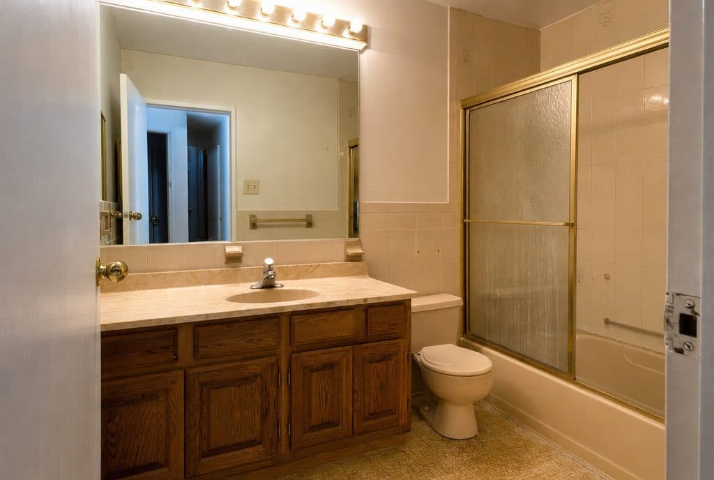 Dated beige bathroom before renovation