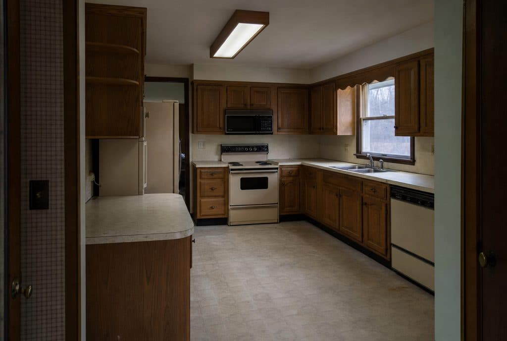 Dated 1990s kitchen with oak cabinets before renovation